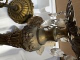 a bird that is sitting next to a chandelier