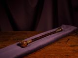 purple cloth with a wooden handle on a wooden table