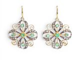 an image of a pair of earrings with green and white stones