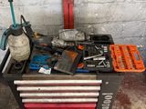 a tool box with tools on it in a garage