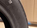 the tire of a car is sitting on the floor next to a cardboard box