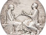 une image représentant une pièce d'argent sur laquelle figurent une femme et un homme