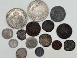 several different types of coins are arranged on a white surface