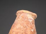 a hand holding a small brown vase with a black background