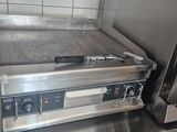 stainless steel counter top with oven and toaster on it in a commercial kitchen