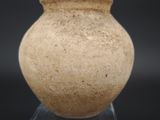 a vase that is sitting on a stand on a black background