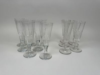 six clear wine glasses sitting on top of a white table