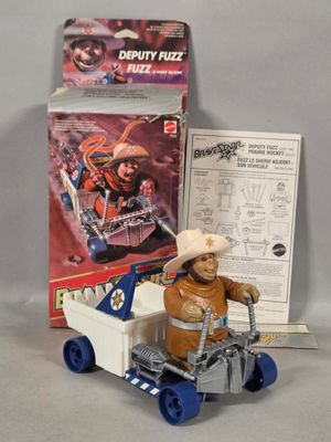 toy figure of a man in a cowboy hat riding a toy truck