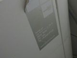 a sign on the side of a refrigerator in a kitchen