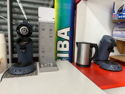 a coffee maker and a coffee cup on a counter