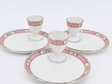 a set of four cups and saucers on a white table