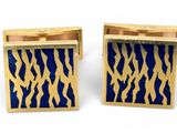 a pair of blue and gold cufflinks with zebra print