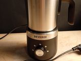 silver and black blender sitting on top of a wooden table
