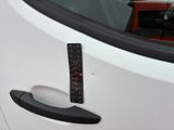 a close up of a car door handle with a ruler on it
