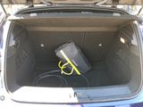 the trunk of a car with a bag and a hose in it