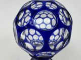 a blue vase with white dots on it on a table