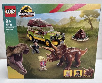 the box is open to show the contents of the lego jurassic park set