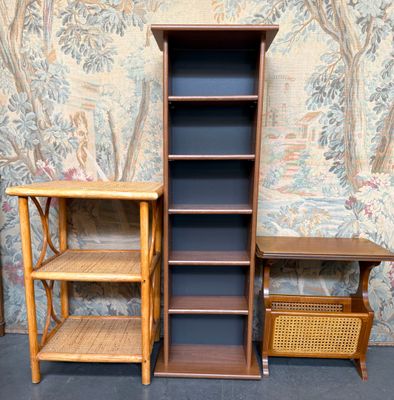 two bookshelves and a table in front of a wallpapered wall