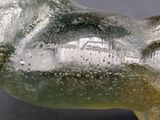 a glass sculpture of a horse that is sitting on a table