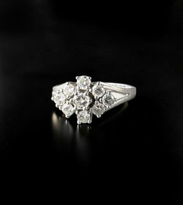 a close up of a diamond ring on a black surface