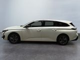 the white car is parked on the concrete floor in the room