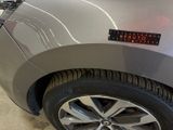 a close up of a car ' s tire with a sticker on it