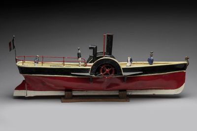 a model of a steam powered boat on a wooden stand