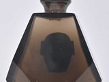 brown glass perfume bottle with a wooden stopper on a white surface