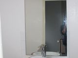 a white sink sitting under a mirror in a bathroom