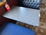 a small table with a blue chair in front of it