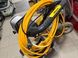a yellow hose on the floor next to a red door