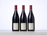 three bottles of wine sitting on top of a table next to each other