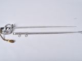 a close up of a metal object with a handle on a white surface