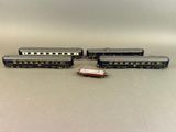three toy trains sitting next to each other on a table