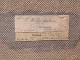 an old piece of paper with writing on it sitting on top of a table