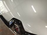 a close up of a car ' s bumper and tail light