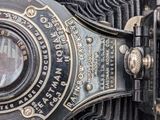 a close up of an old camera with a lens on it