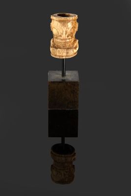 an image of a sculpture of a vase on top of a wooden stand