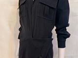 the mannequin is wearing a black shirt and white pants