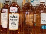 several bottles of wine are lined up on a table