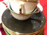 a stack of plates and cups on a table