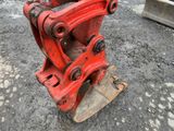 a red machine that is sitting on the ground
