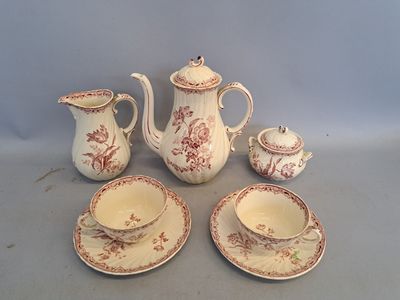 a tea pot, cup, saucer, and saucer on a table