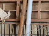 a man that is standing in front of a pile of wood