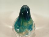 a glass bird that is sitting on top of a table