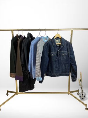 a rack with clothes and a skateboard on it