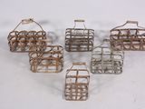 six small metal baskets with handles and handles on a white surface
