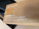 a box that has a steering wheel cover on top of it