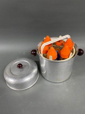 carrots in a metal container with a lid and a spoon