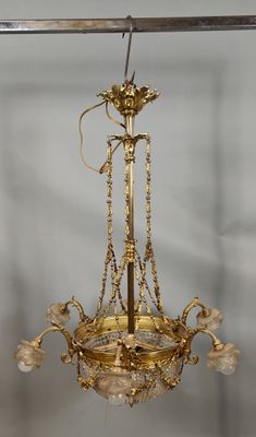 a gold chandelier hanging from the ceiling in a room